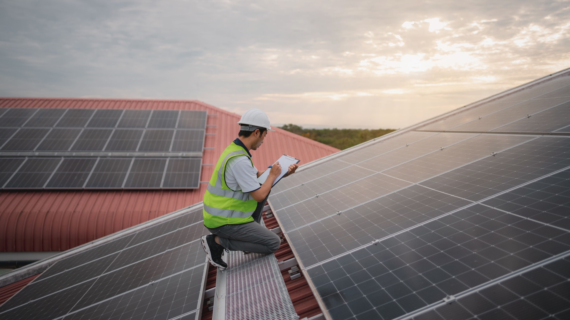 Service engineer checking solar cell on the roof for maintenance if there is a damaged part. Engineer worker install solar panel. Clean energy concept.